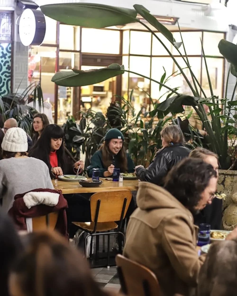 People enjoying meals together at Everybody Eats restaurant