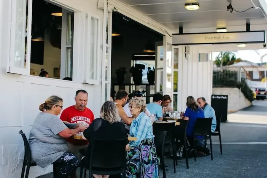 Diners sharing kai outside the Everybody Eats restaurant