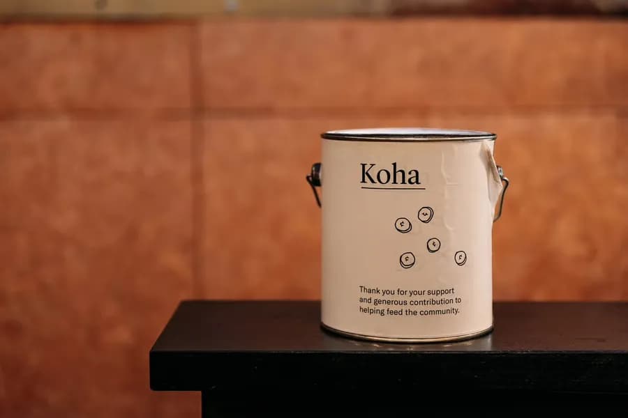 A koha tin thanking diners for their pay-what-you-can support