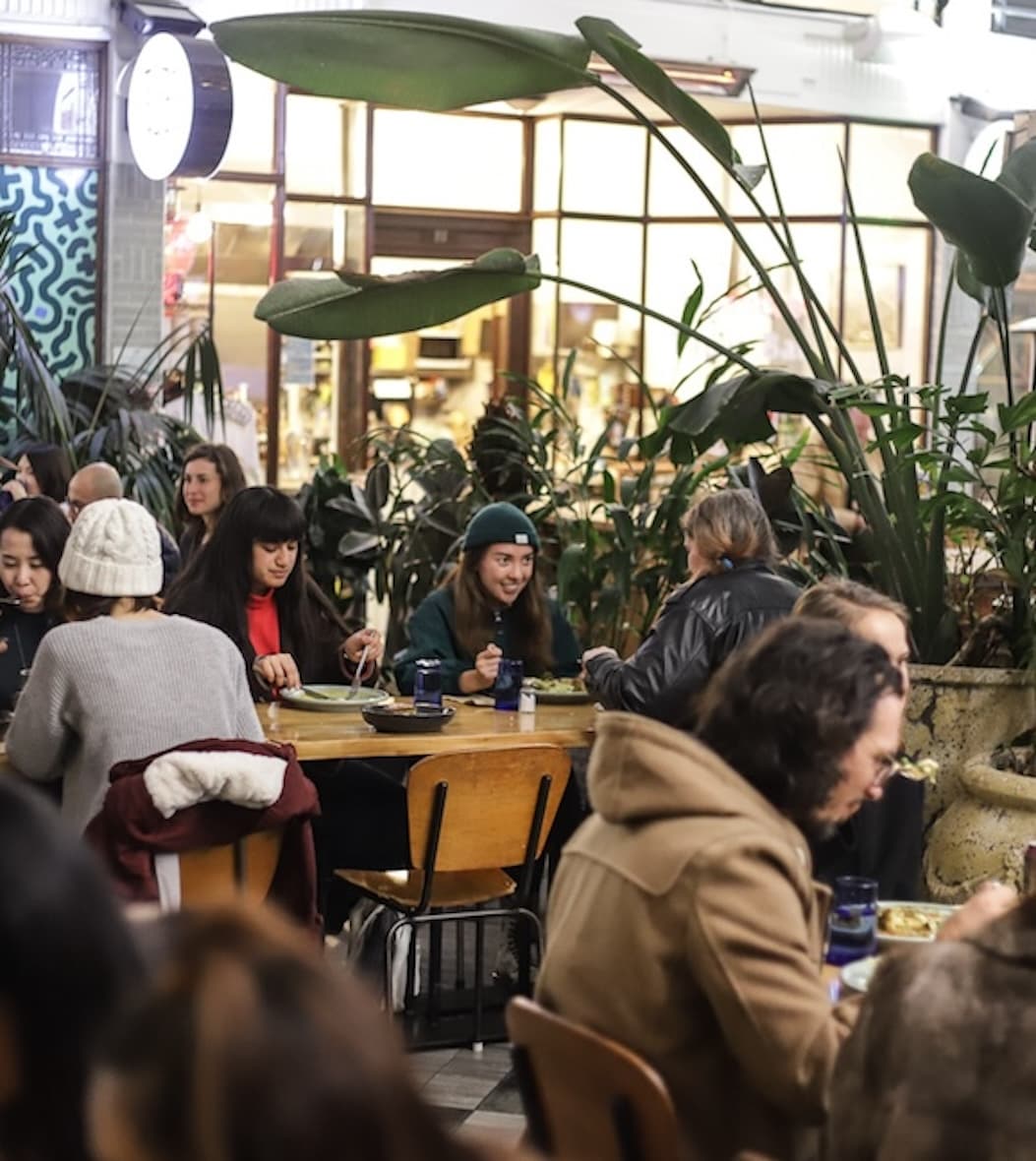 People enjoying meals together at Everybody Eats restaurant